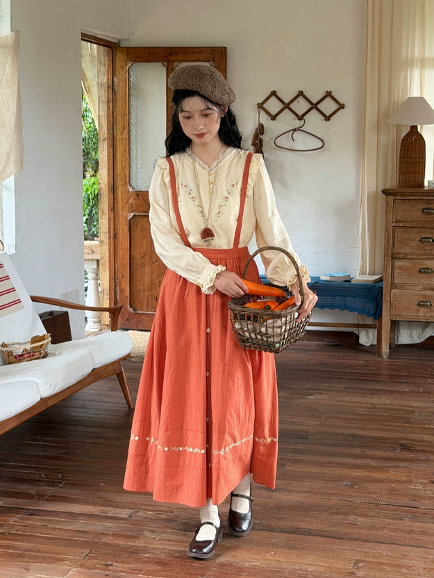 Cottagecore rust maxi skirt with button front and floral hem embroidery styled with a cream romantic blouse