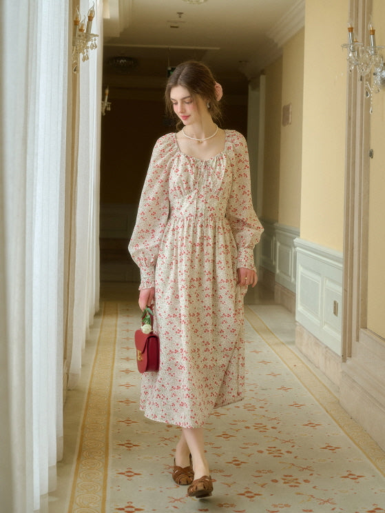 A young woman walking down a vintage aesthetic hallway in a retro floral dress with a gathered bodice, carrying a small red handbag and wearing pearl jewelry.