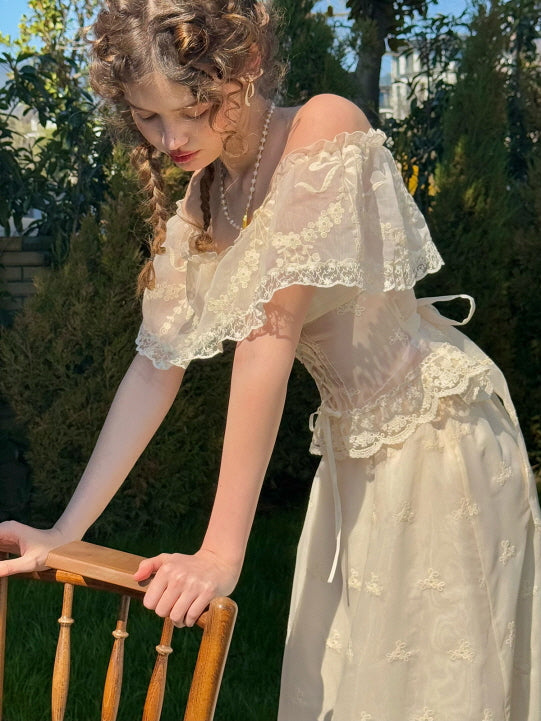 Romantic off-shoulder lace corset dress in ivory, featuring floral embroidery and vintage-inspired silhouette, styled in a garden with natural sunlight – women's fairytale aesthetic fashion
