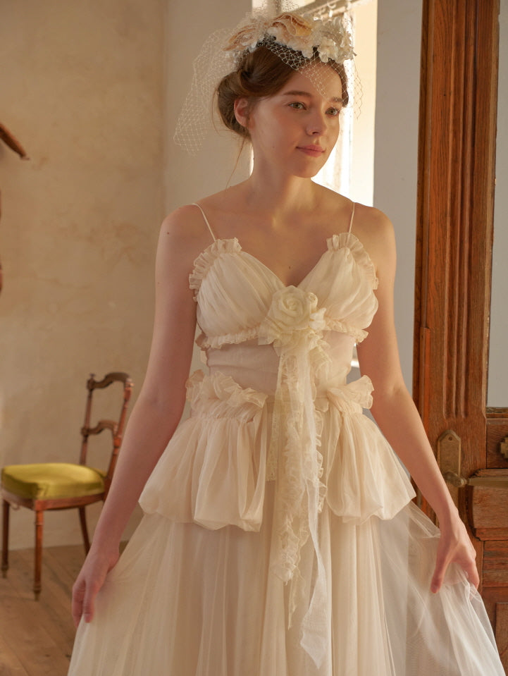 Woman in soft cream ruffled tulle outfit, walking through a vintage cottage room, evoking a romantic and fairycore aesthetic
