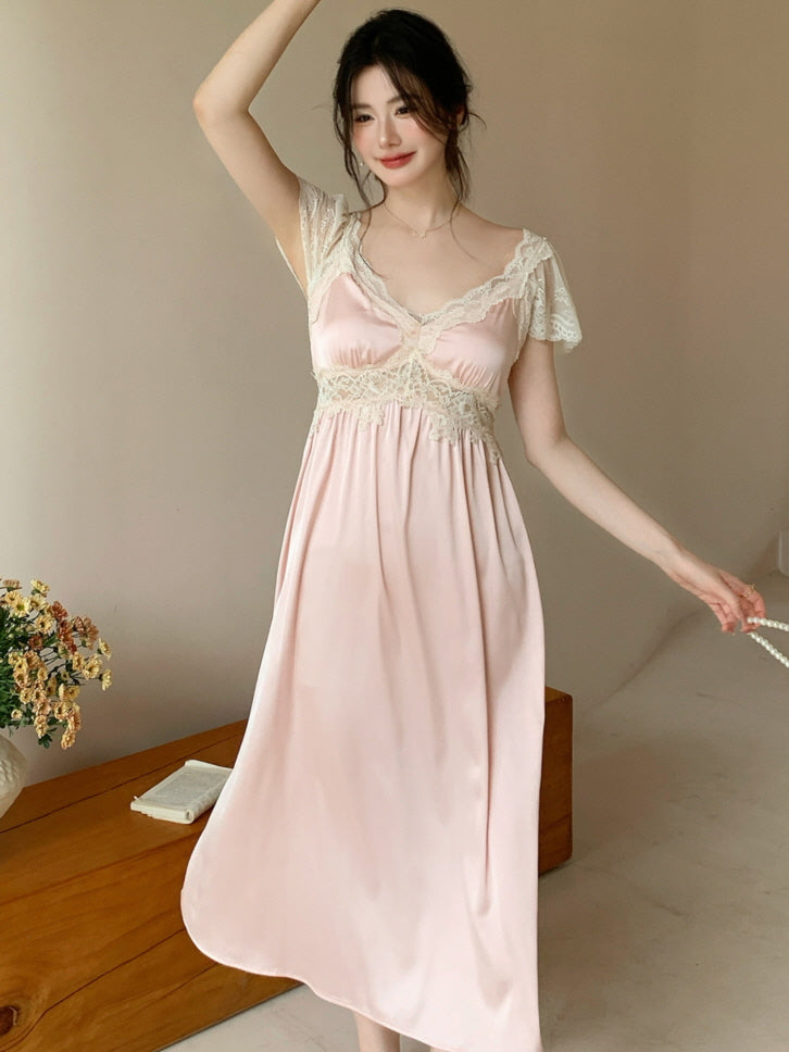 Model gracefully poses in a soft pink lace nightdress with short sleeves, evoking romantic princesscore charm in a cozy cottagecore setting.