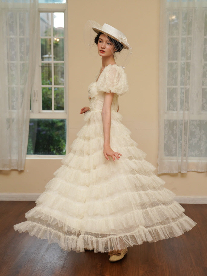 Gracefully turning in a flowing ivory gown, the model captures a dreamy princesscore moment with delicate textures and timeless charm.