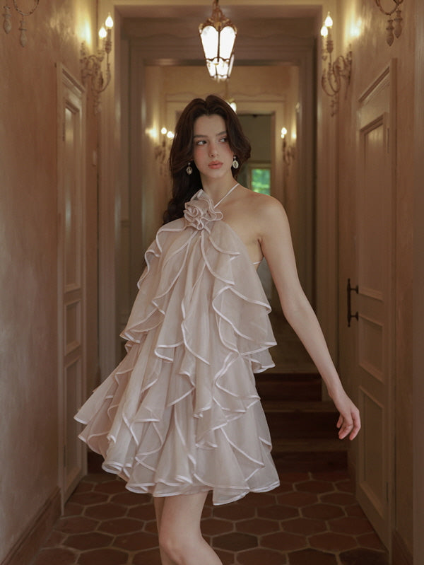 Walking gracefully down a softly lit hallway, the model wears a layered halter dress that flows with romantic elegance and fairycore style.