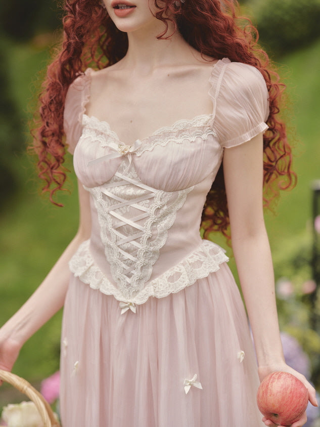 Close-up of a vintage-inspired blush corset fairytale dress with lace trim, puff sleeves, and ribbon details, styled in a dreamy princesscore look.