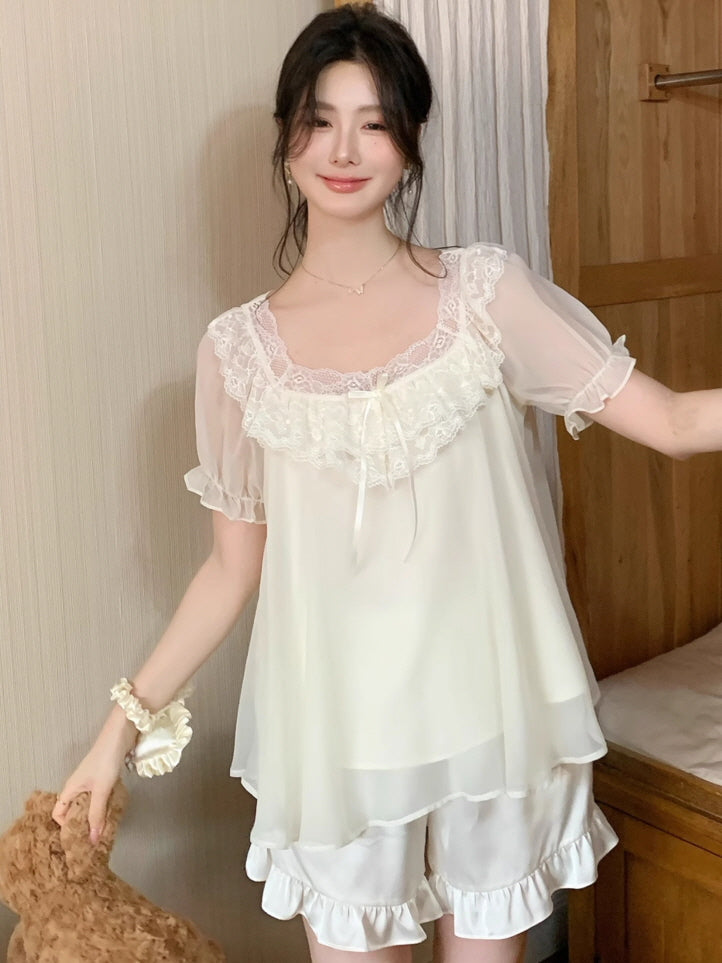 Model wearing a vintage-style ivory loungewear set with puff sleeves and lace trim, standing by a wooden bed in a cozy fairycore room.