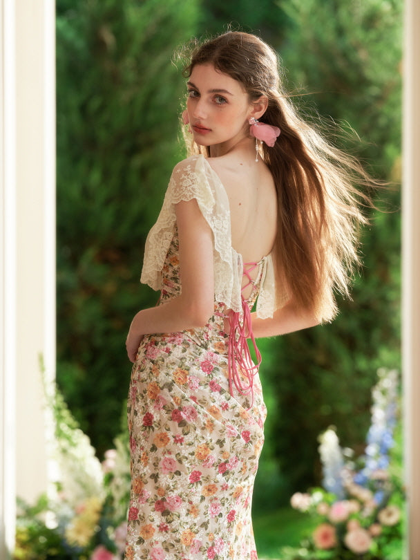 Back view of a floral corset-style dress with pink ribbon lacing and lace sleeves, styled with soft waves for a dreamy romantic fairycore mood.