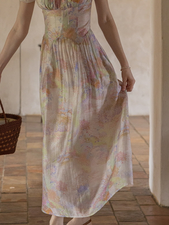 Close-up view of a pastel floral dress with delicate pleats and soft, watercolor-inspired patterns, capturing a romantic, vintage-inspired charm.