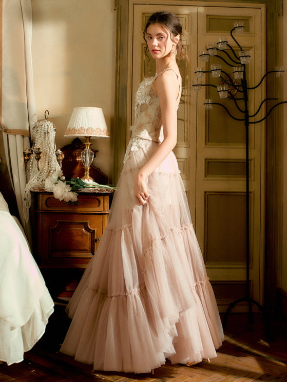 The model stands in profile wearing a sheer tiered tulle skirt and floral lace corset, evoking vintage elegance and soft princesscore allure.
