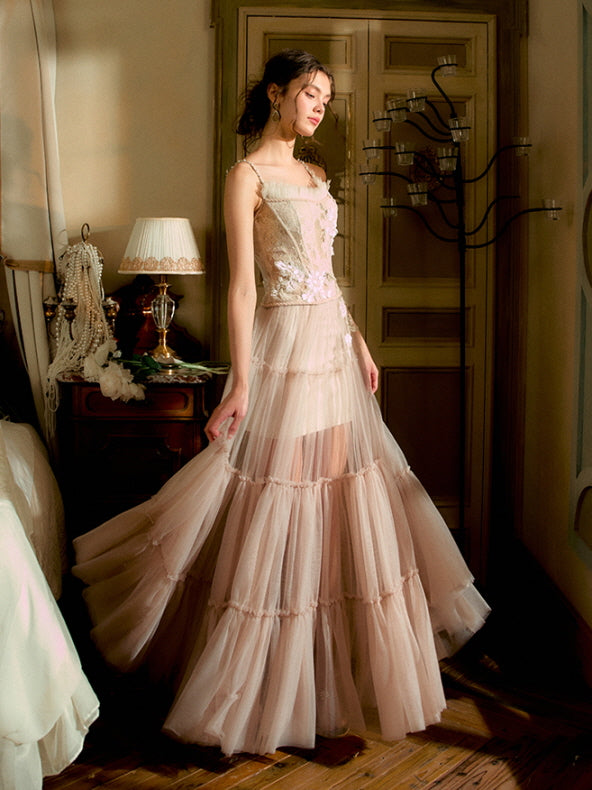 Bathed in golden light, the model gently sways her tiered tulle skirt while wearing a blush floral corset, creating an ethereal princesscore silhouette.