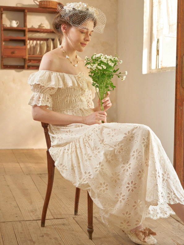 Sitting by the window in a vintage-inspired dress, a woman holds a bouquet of daisies with a gentle smile, evoking peaceful cottagecore charm.