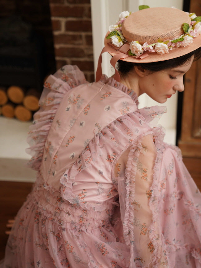 Close-up of the back of a pink ruffle dress and floral hat, highlighting delicate details in a romantic princesscore interior.