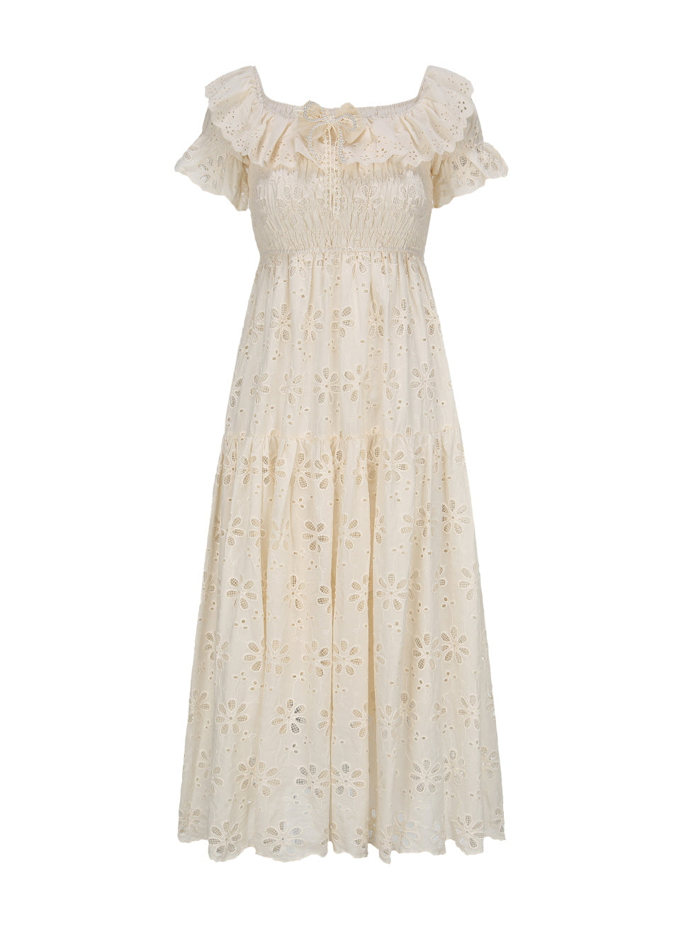 Flat lay of a cream off-shoulder lace dress with ruffle details and floral eyelet pattern, perfect for a fairytale-inspired summer outfit.
